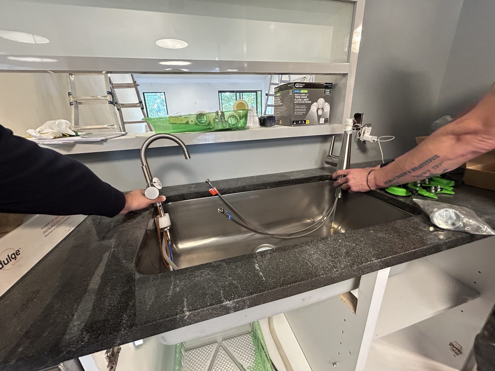 BUILD IN NYC team installing kitchen plumbing fixtures during renovation work
