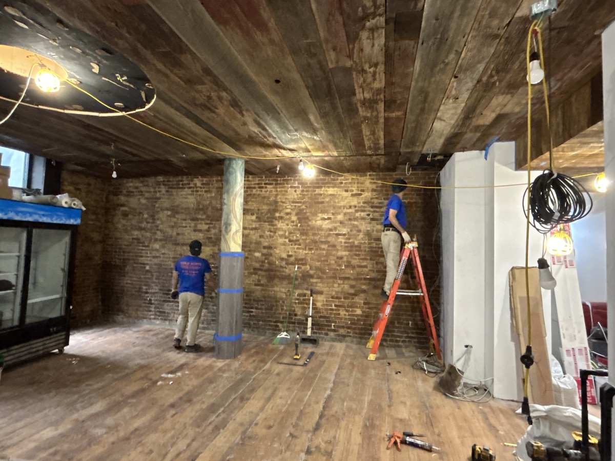 BUILD IN NYC crew coordinating interior restaurant renovation work on site