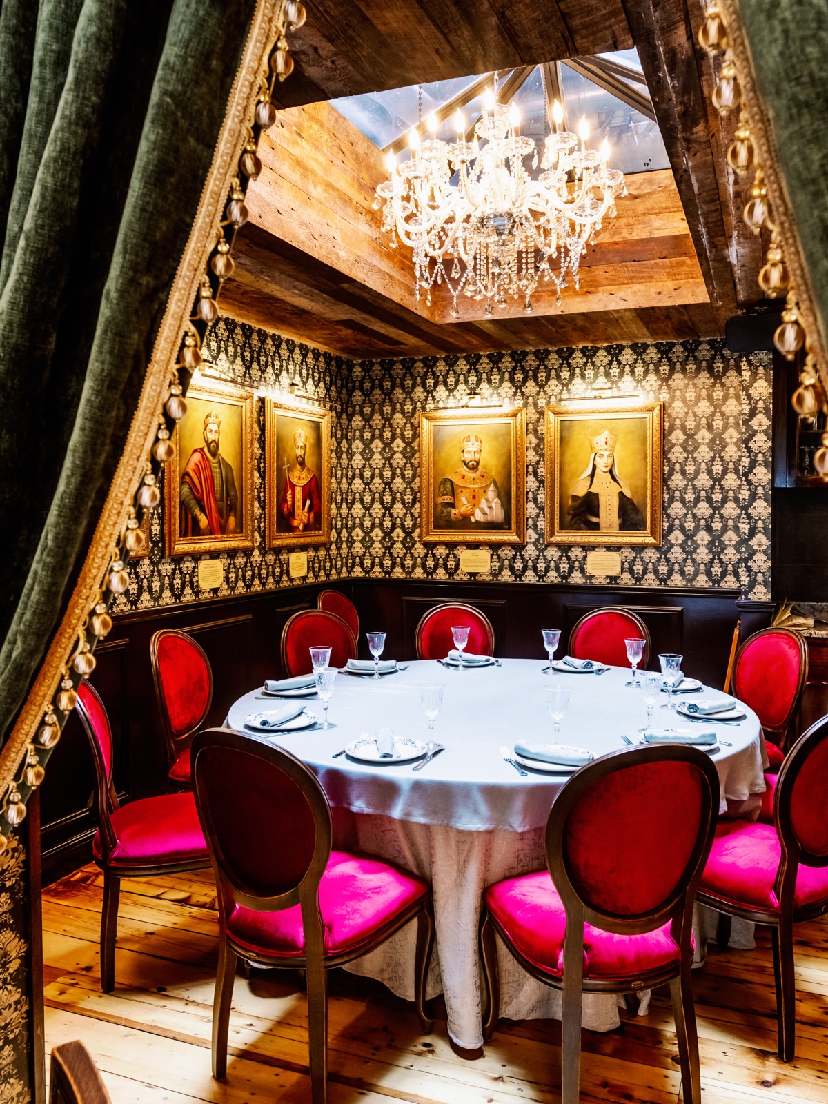 The History Restaurant Hell's Kitchen private dining room with green velvet drapery and red chairs
