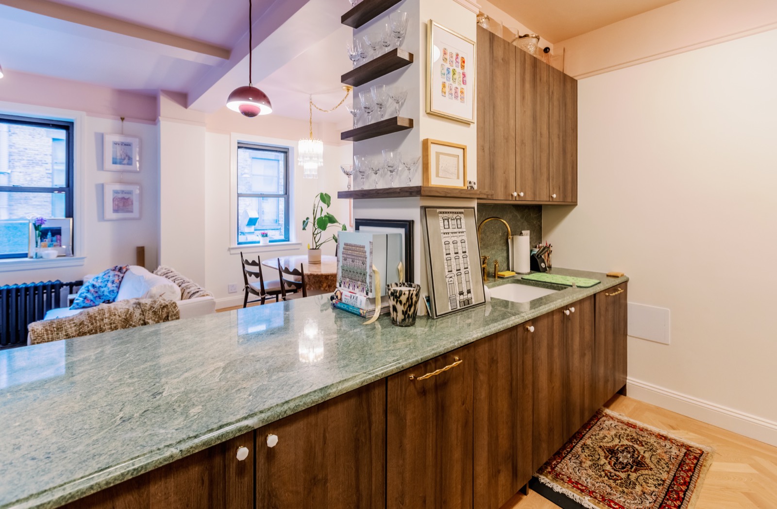 Kitchen with green stone counter, wood cabinetry, and open shelving