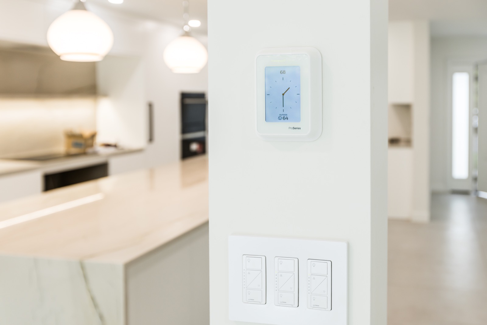 Smart thermostat and lighting controls in a modern renovated interior